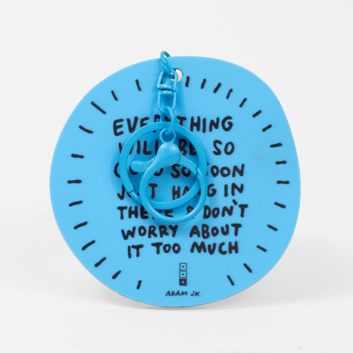 Blue keychain with "EVERYTHING" quote by Adam JK on a white background