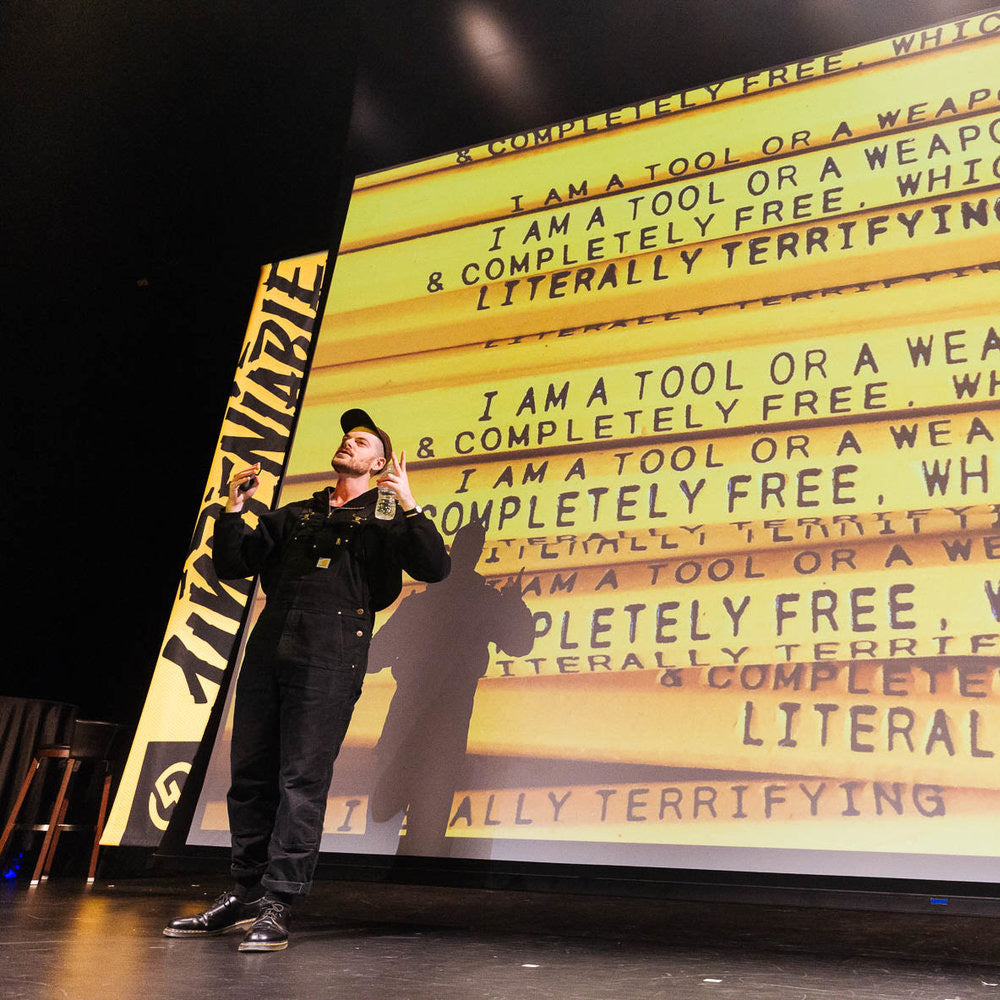 Photo of Adam speaking on conference stage