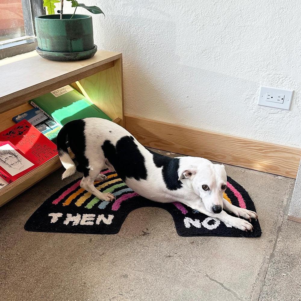 Adam's dog stretches on Then & Now floor rug