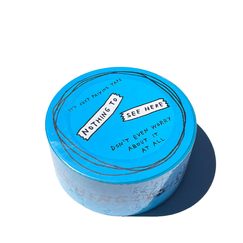 Blue packing tape reads "NOTHING TO SEE HERE" in Adam JK's signature handwriting