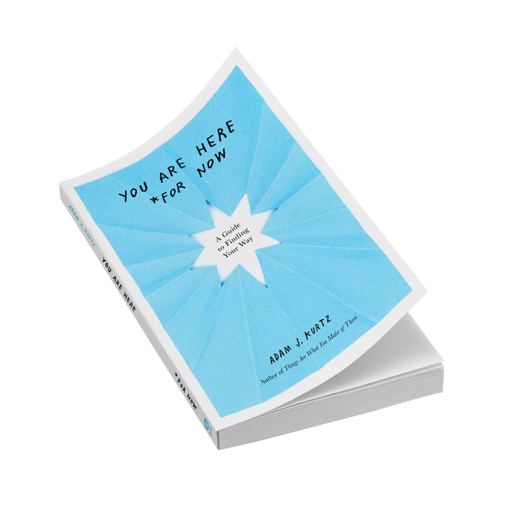 YOU ARE HERE *FOR NOW book by Adam J. Kurtz. Photo of book on white shows cover design featuring blue paper with a star cut from the center and handwritten text.